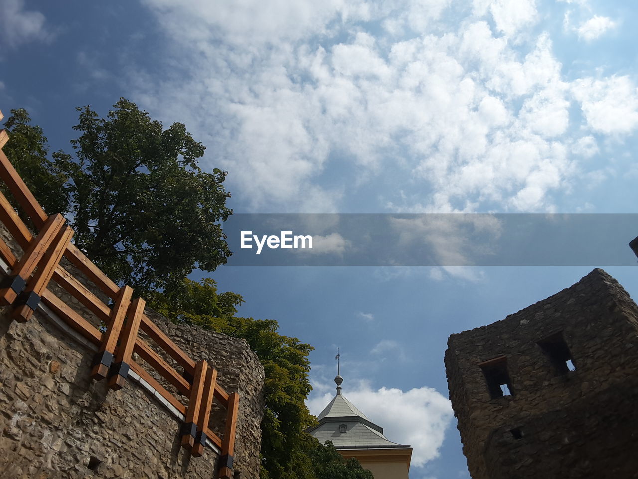 Low angle view of building against cloudy sky