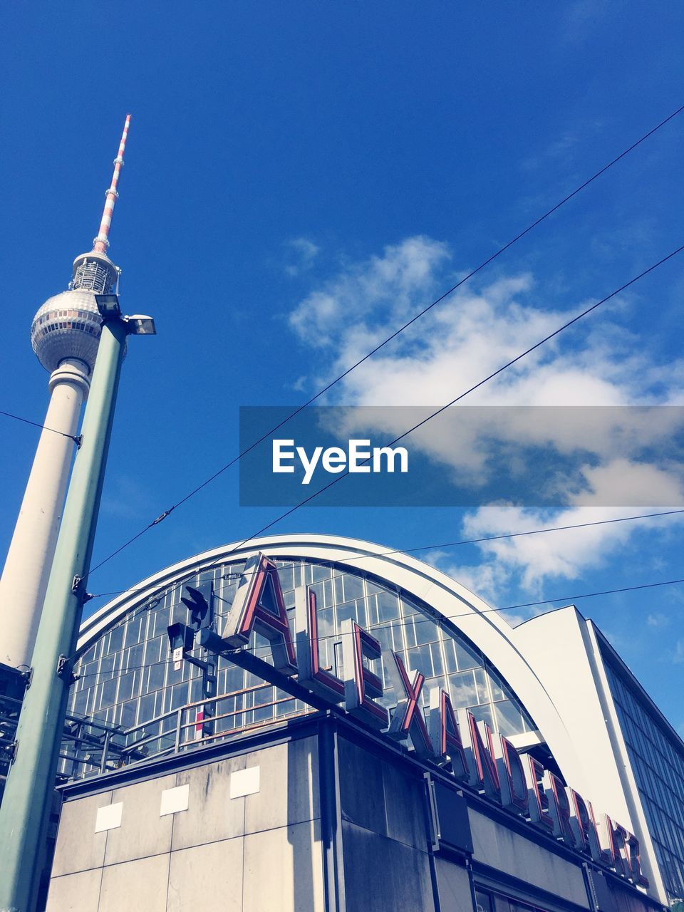 Low angle view of fernsehturm against sky at alexanderplatz in city