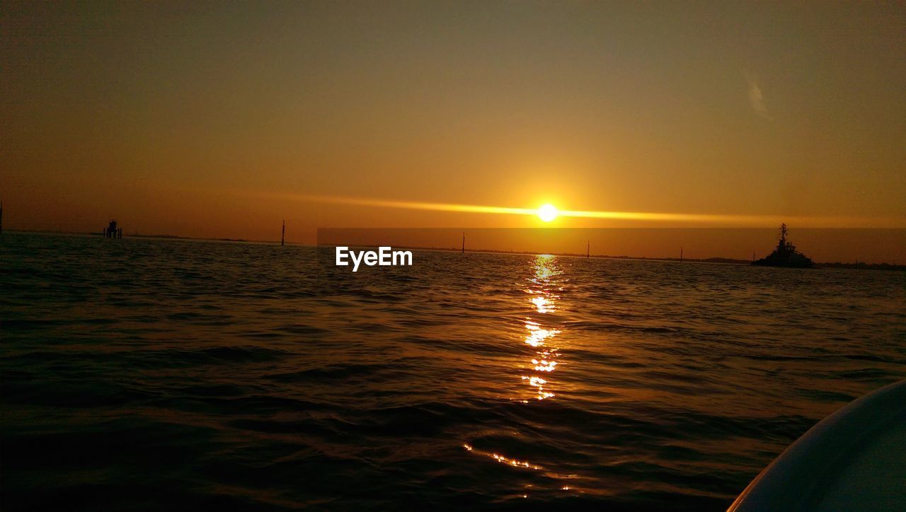 SILHOUETTE OF SAILBOAT SAILING ON SEA