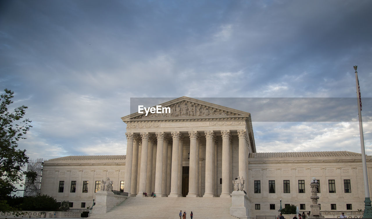 Us supreme court building against cloudy sky
