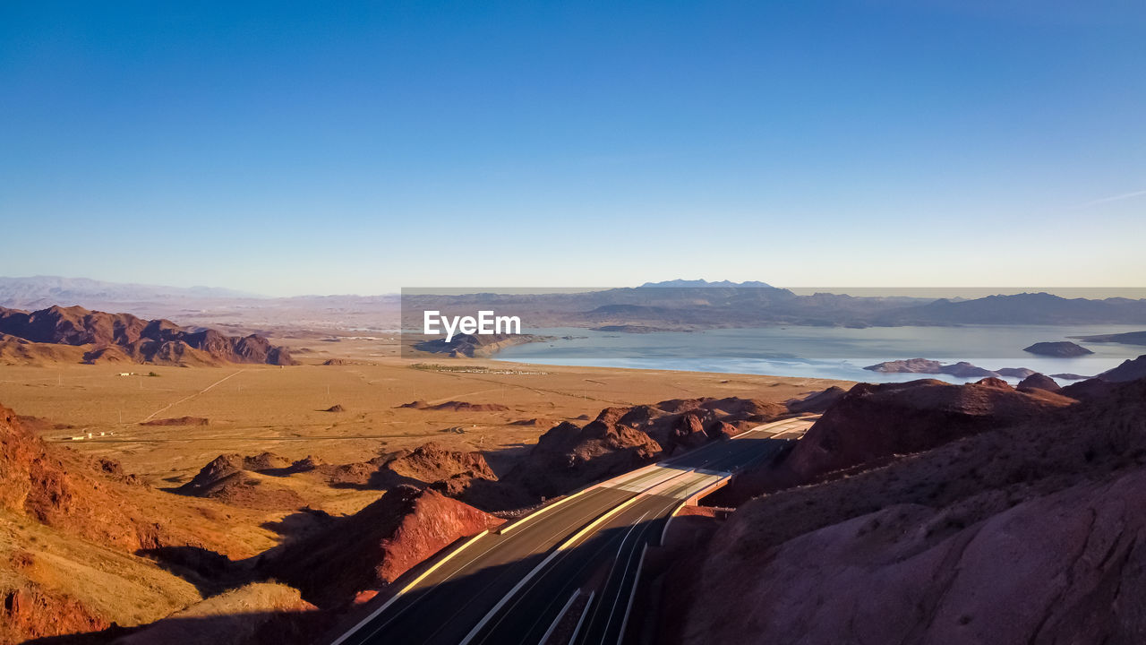 Panoramic view of landscape against clear blue sky