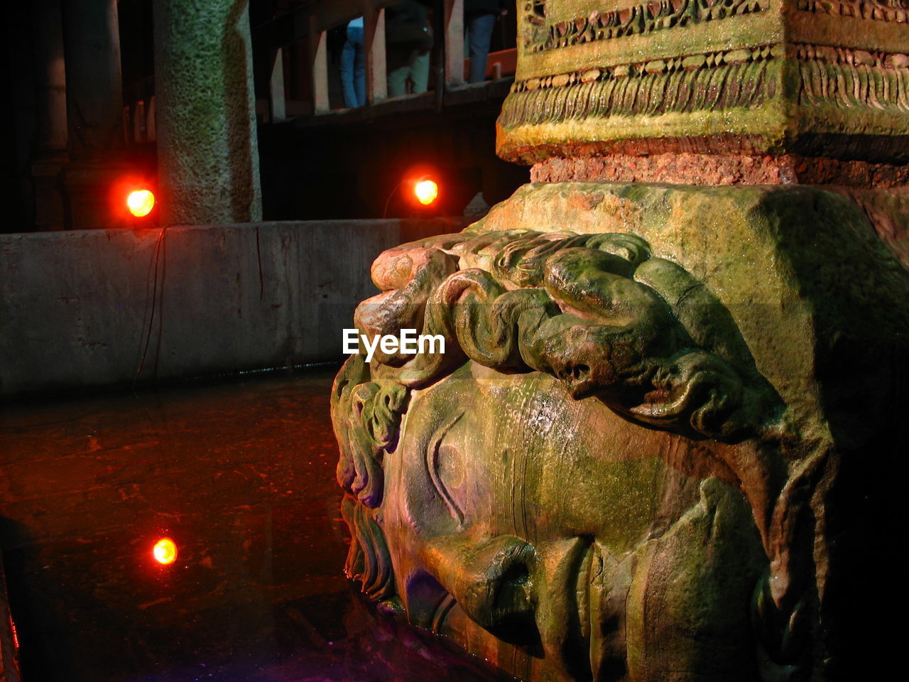 CLOSE-UP OF STATUE AGAINST ILLUMINATED LIGHTS