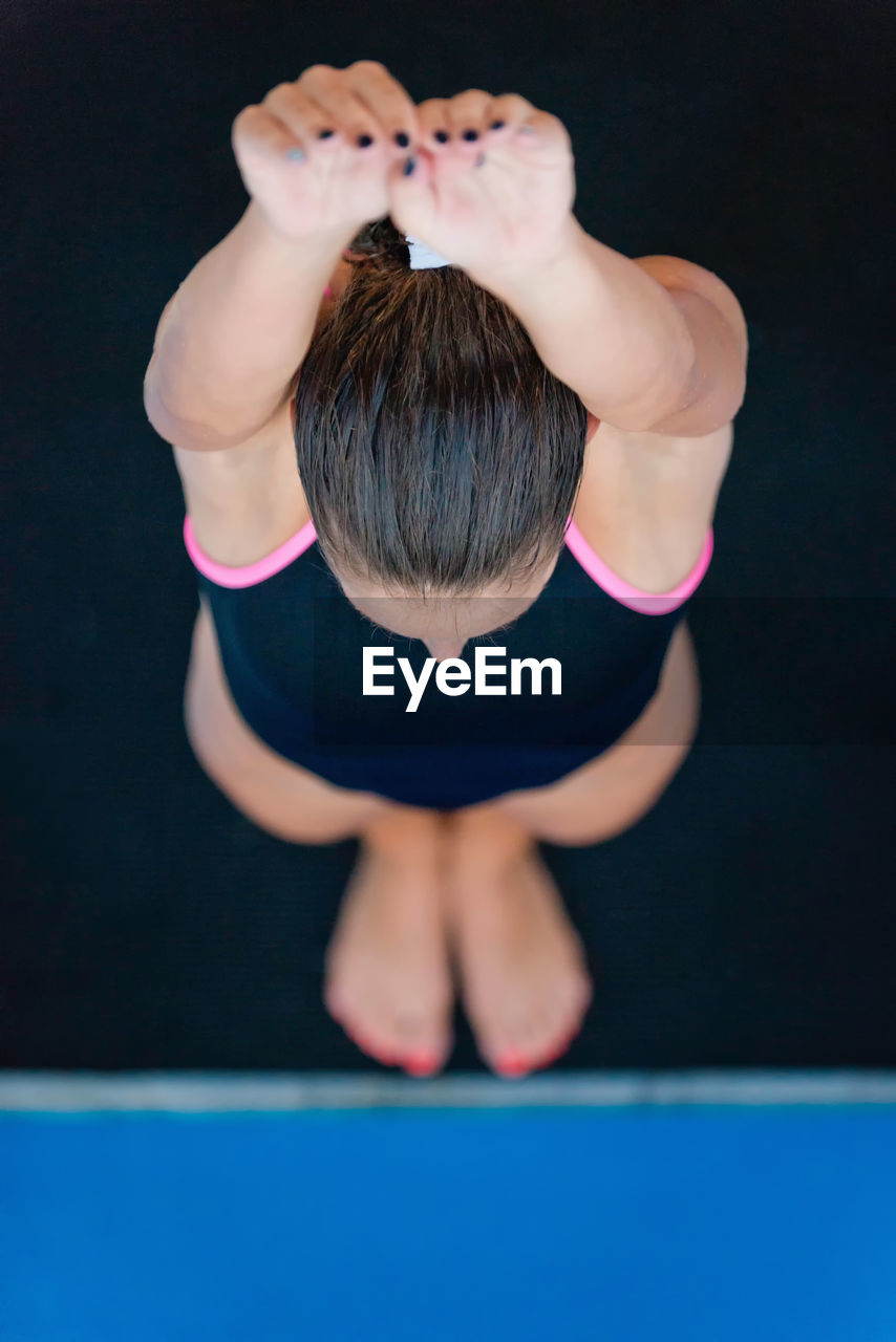 High angle view of woman diving into swimming pool