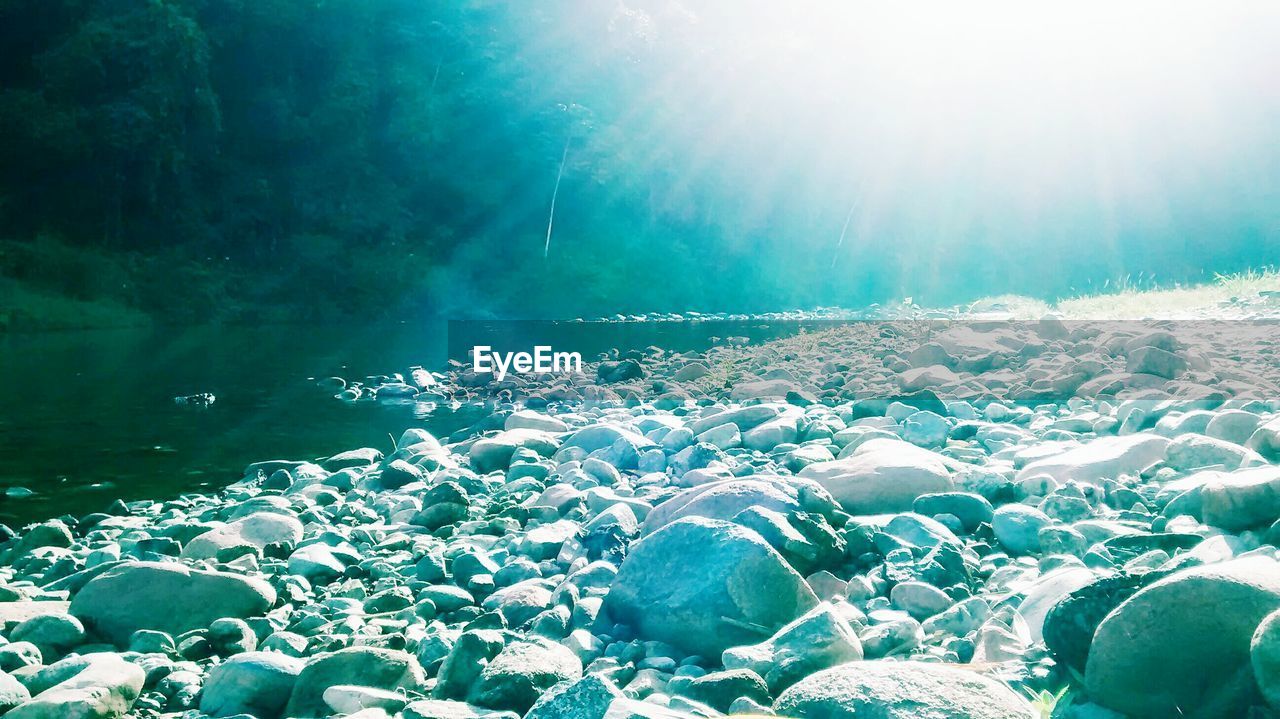 CLOSE-UP OF BUBBLES OVER WATER AGAINST BLUE SKY