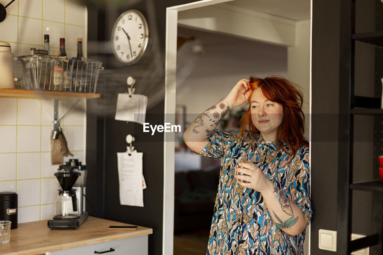 Woman in kitchen looking away