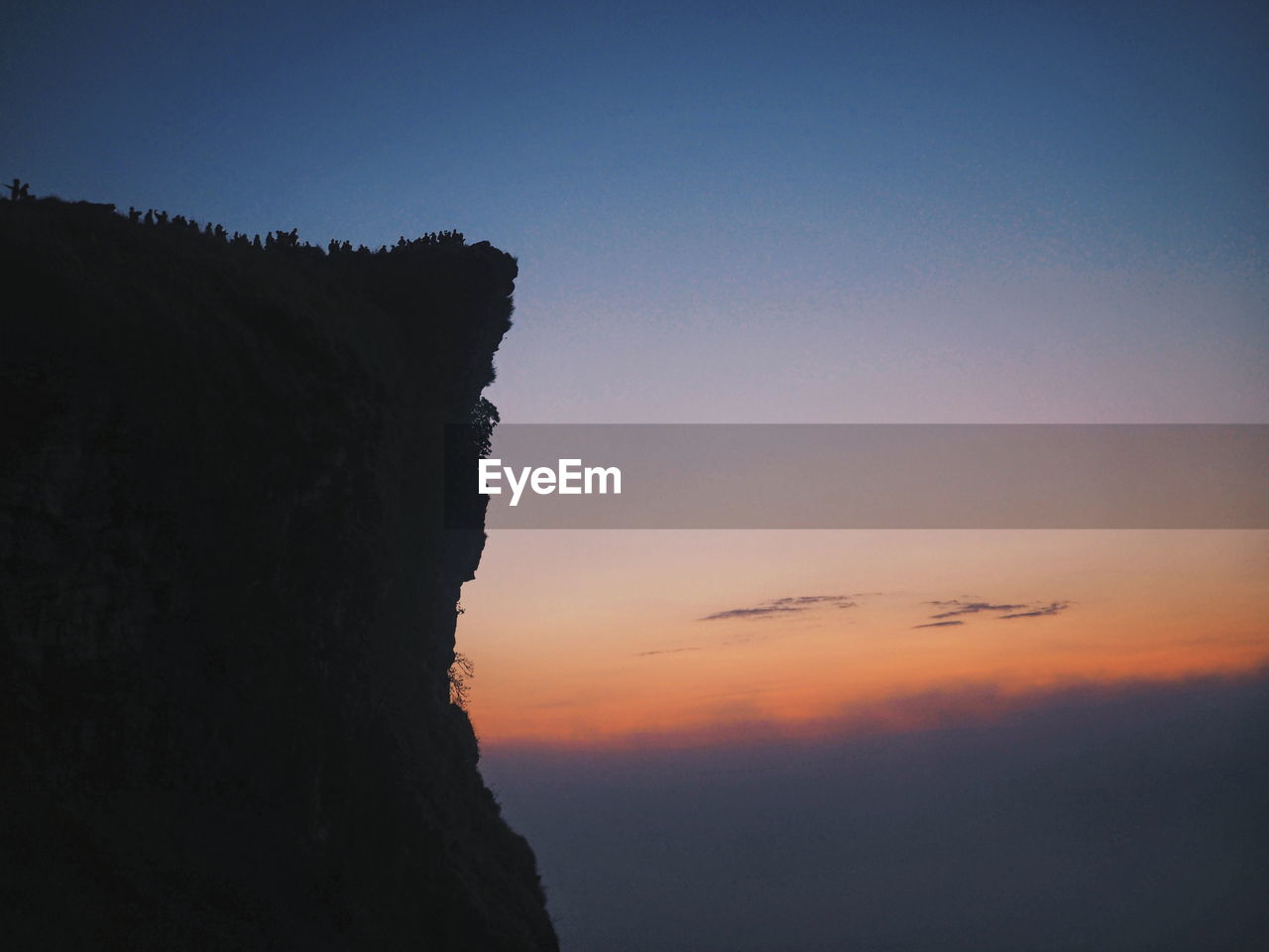 Scenic view of silhouette mountain against sky at sunset