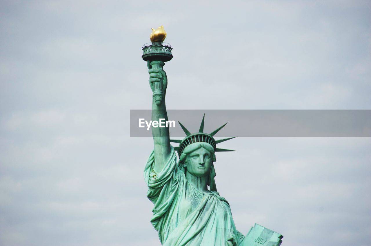 Low angle view of statue of liberty against sky