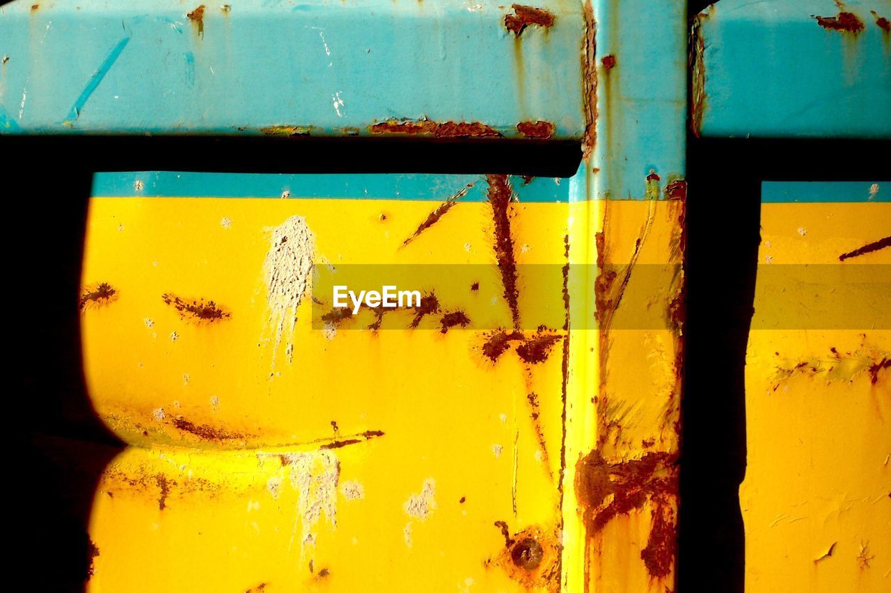 FULL FRAME SHOT OF YELLOW RUSTY DOOR