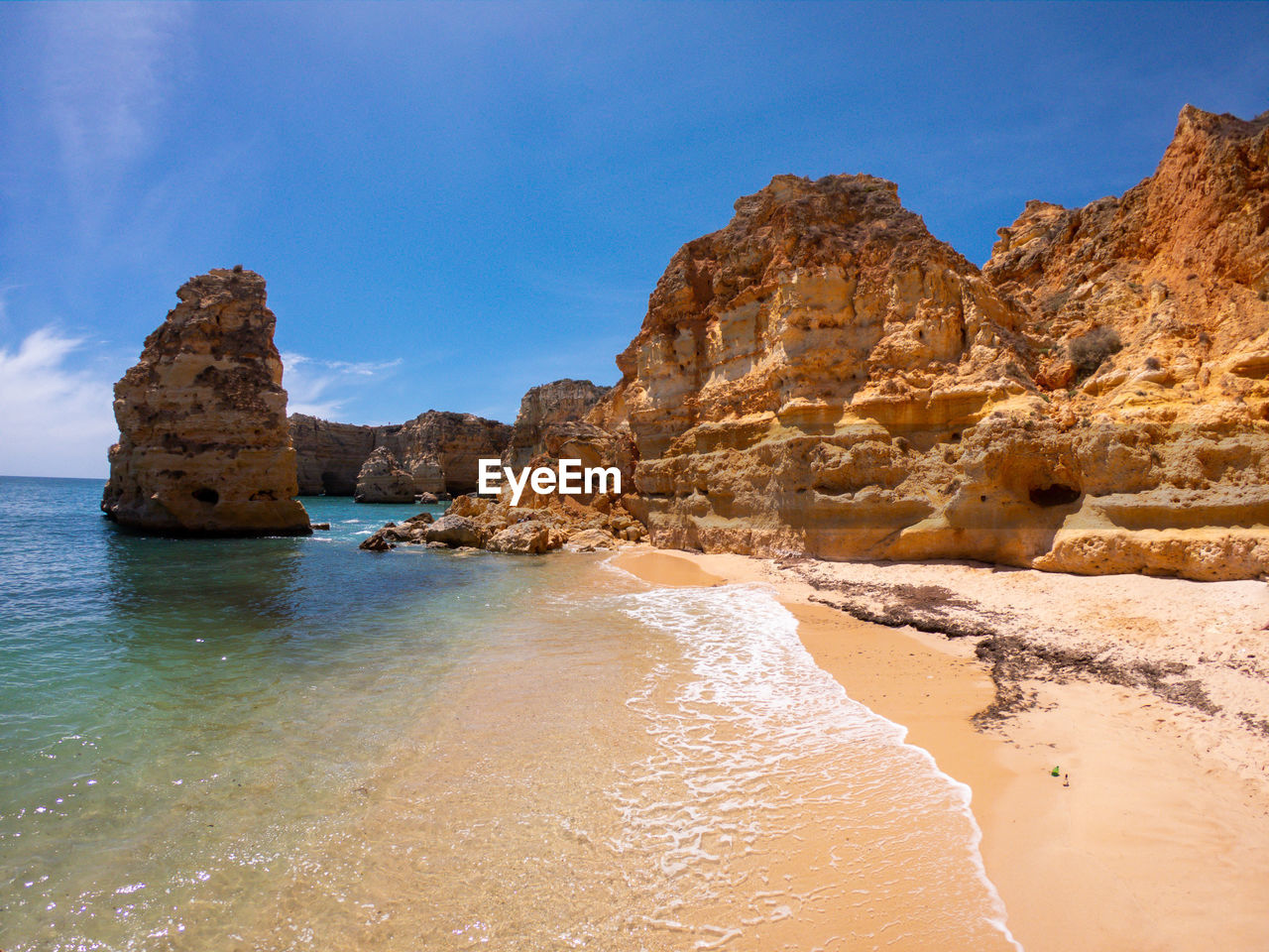 ROCK FORMATIONS IN SEA AGAINST SKY