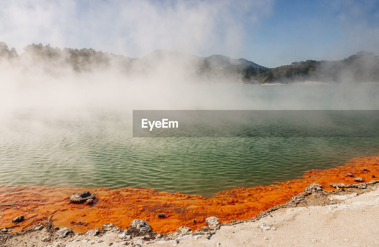 Scenic view of steam over hot spring