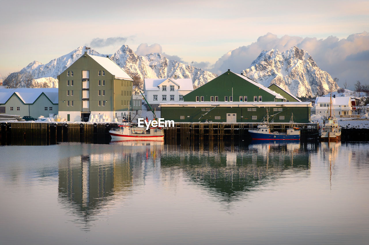 Houses by lake against mountains