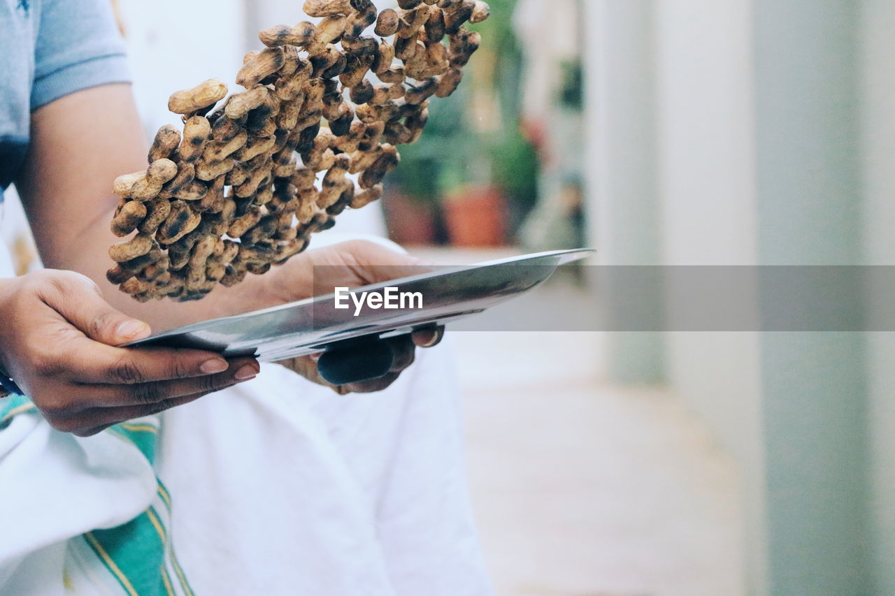 CLOSE-UP OF PERSON HAND HOLDING BREAD