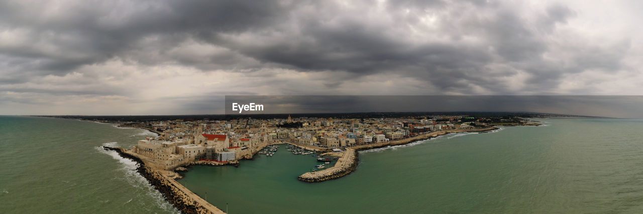 water, sea, cloud, sky, coast, nature, land, travel destinations, shore, ocean, environment, horizon, architecture, scenics - nature, beach, travel, terrain, beauty in nature, bay, no people, coastline, horizon over water, outdoors, landscape, panoramic, tourism, animal, day, aerial view, body of water, wave, storm, animal themes, cloudscape