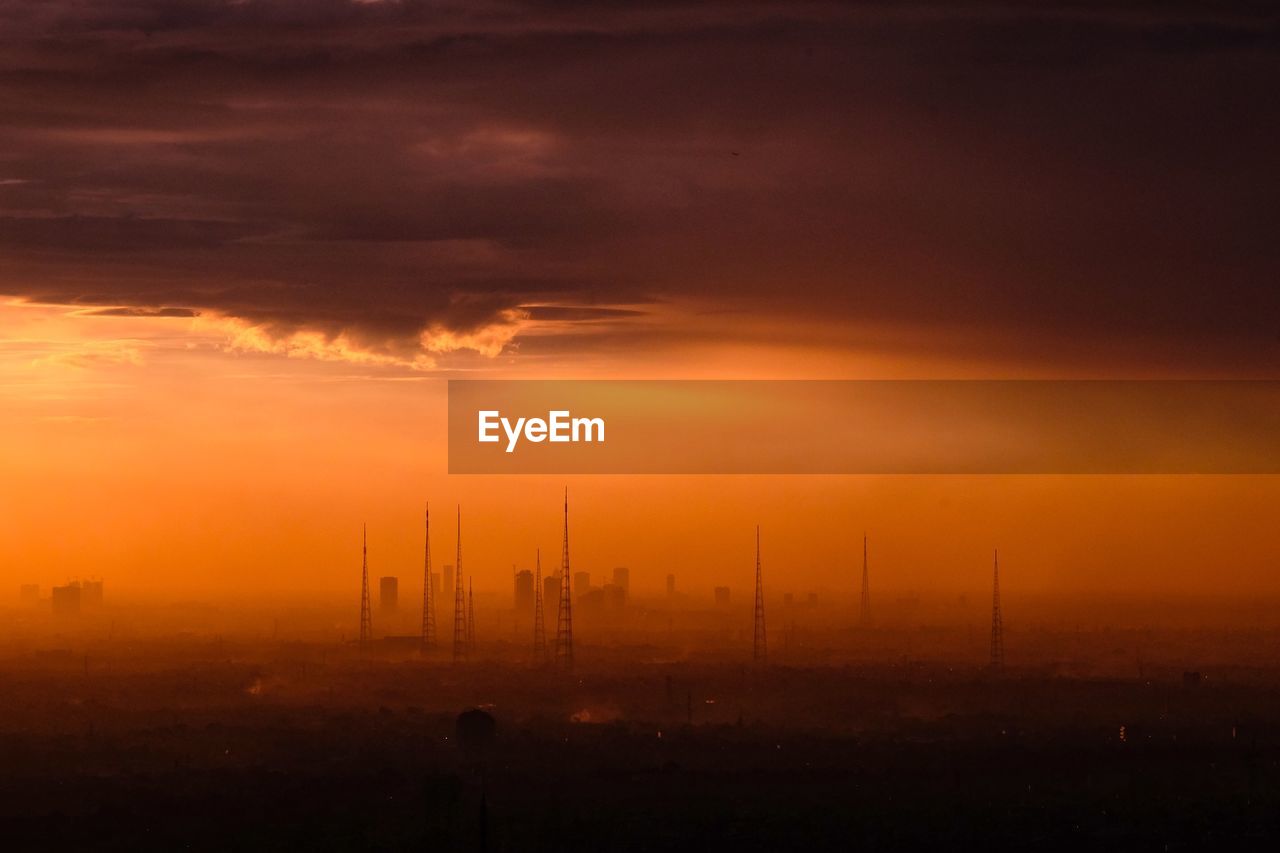 Silhouette landscape against sky during sunset