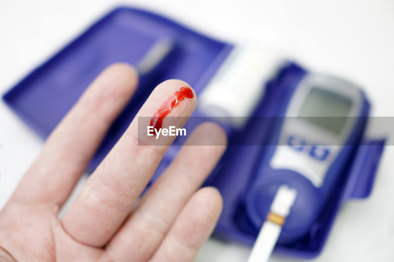 Close-up of blood drop on human finger
