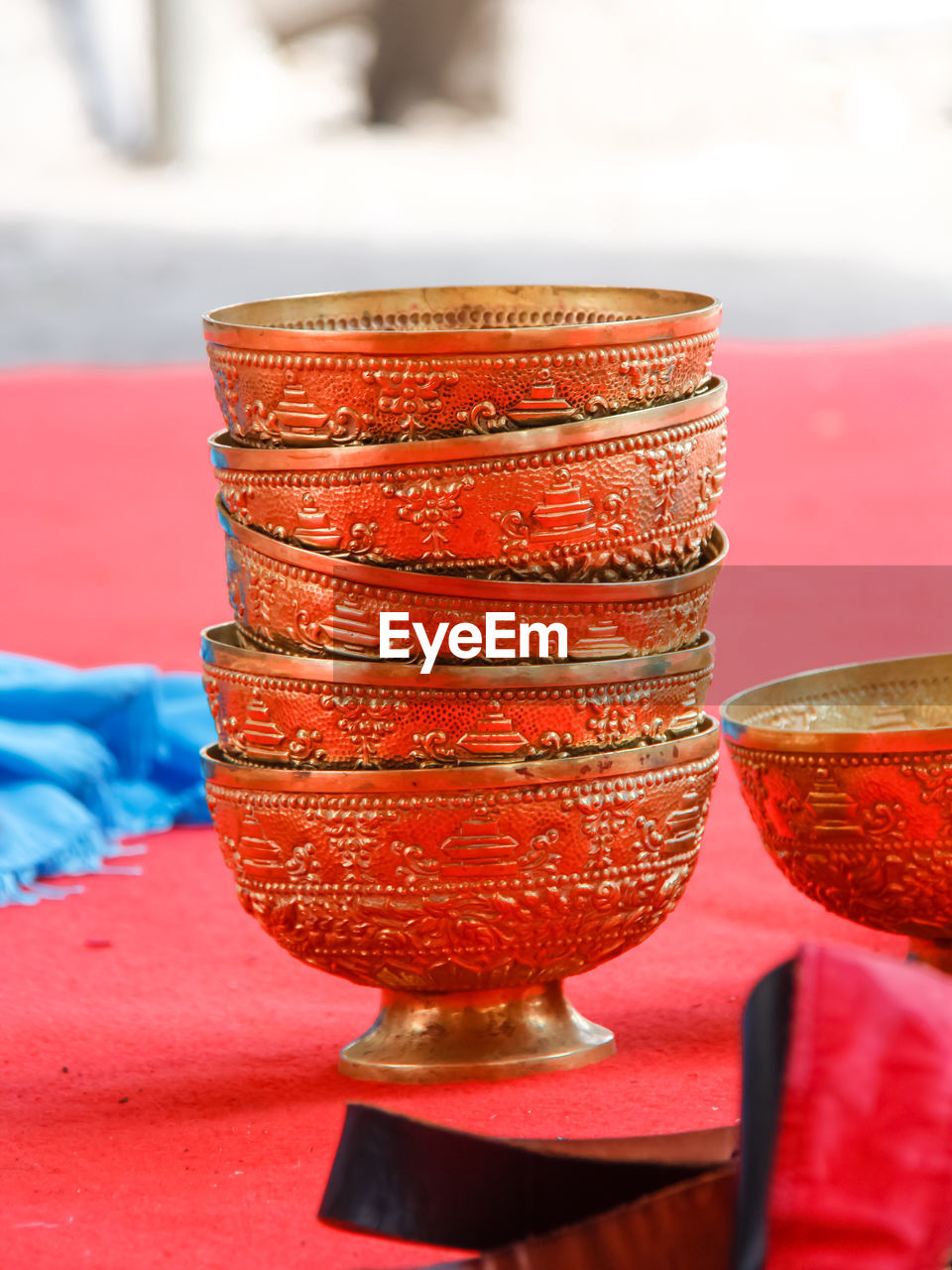 Close-up of carved bowls on table in temple