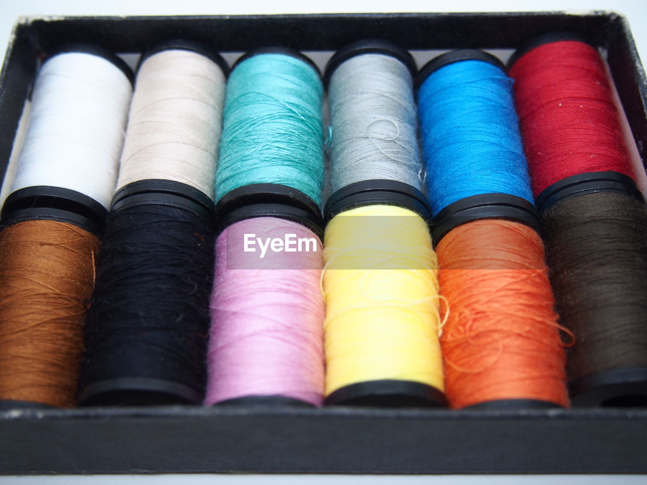 Close-up of multi colored thread spools