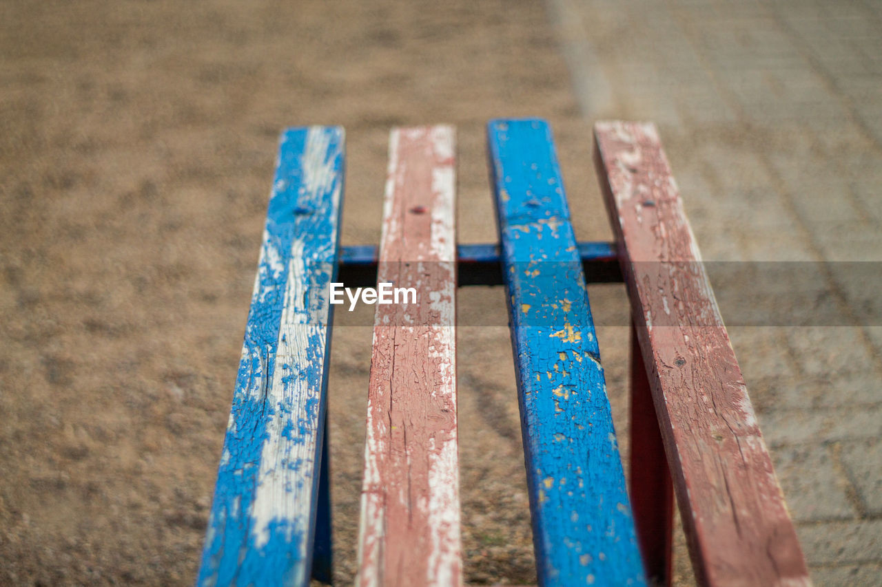 HIGH ANGLE VIEW OF RUSTY METAL ON WOOD