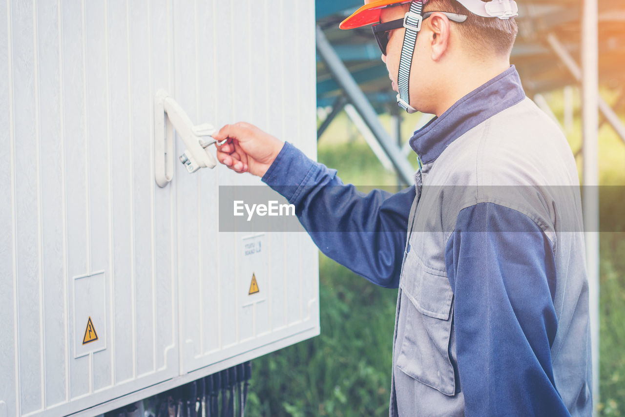 Manual worker opening door with key