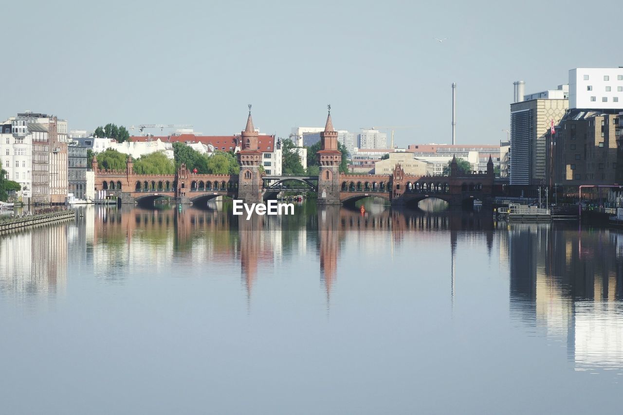 Scenic view of oberbaum bridge over river spree against sky