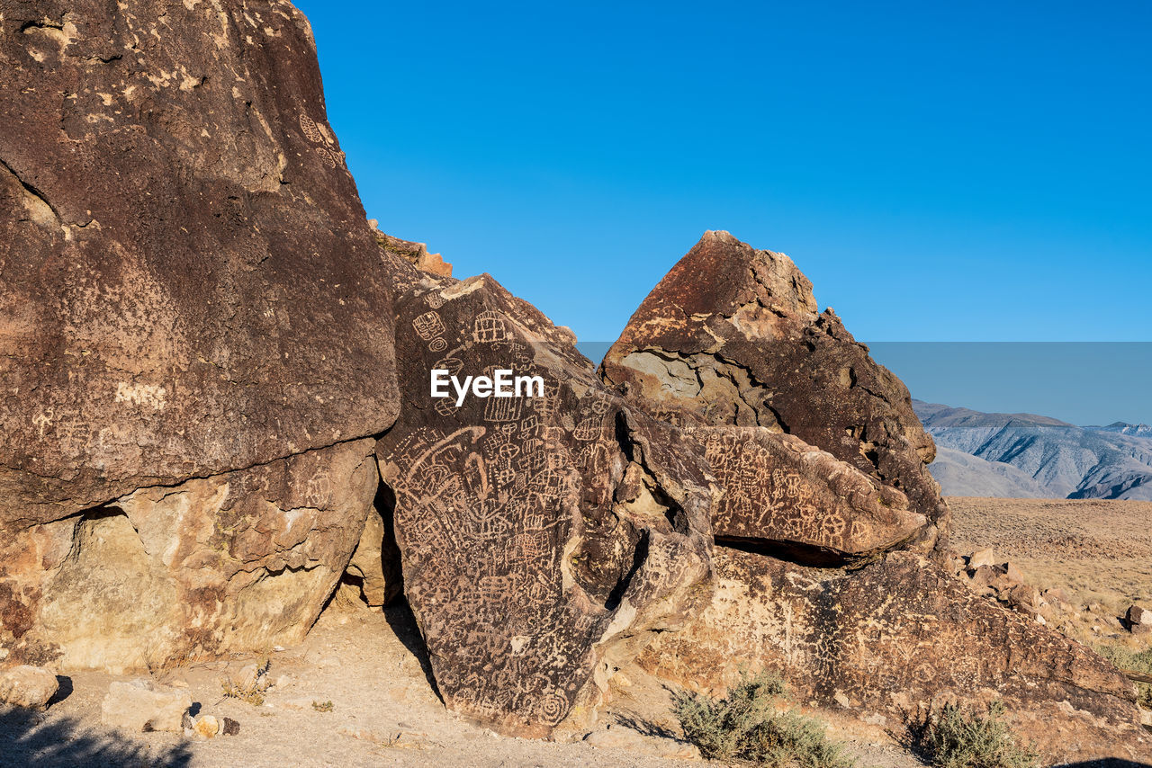 Ancient petroglyph symbols inscribed in rock face  by indigenous peoples of owens valley california