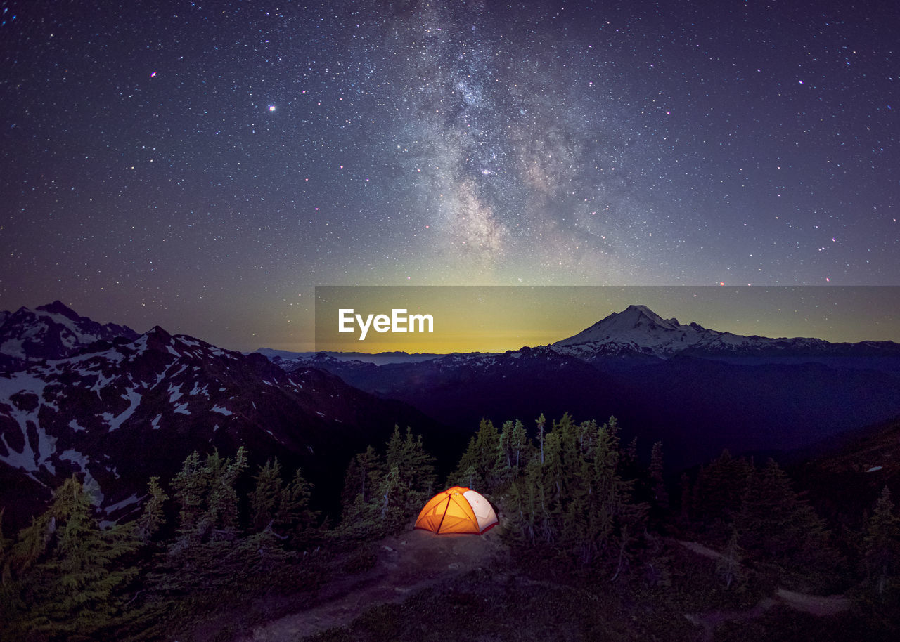 A tent is under the milky way on the top of a mountain, washington, us
