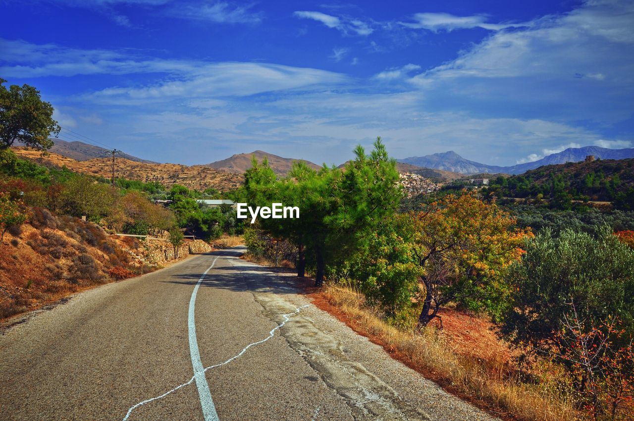 Empty road with mountain in background