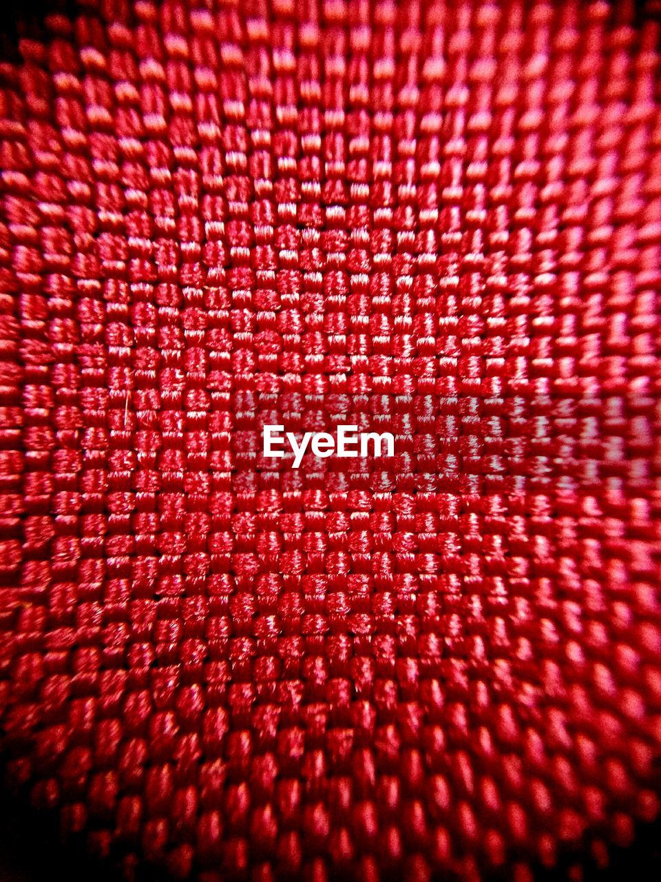 FULL FRAME SHOT OF ABSTRACT PATTERN ON RED FABRIC