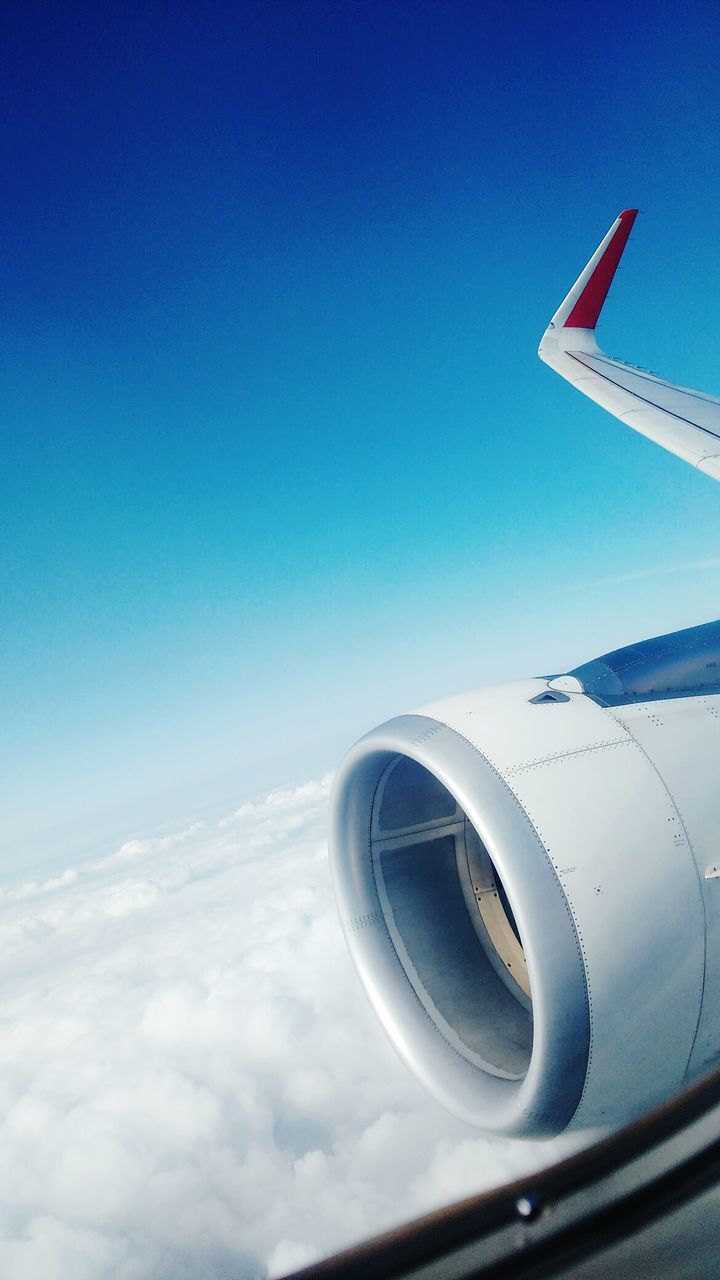 VIEW OF AIRPLANE WING AGAINST CLOUDY SKY