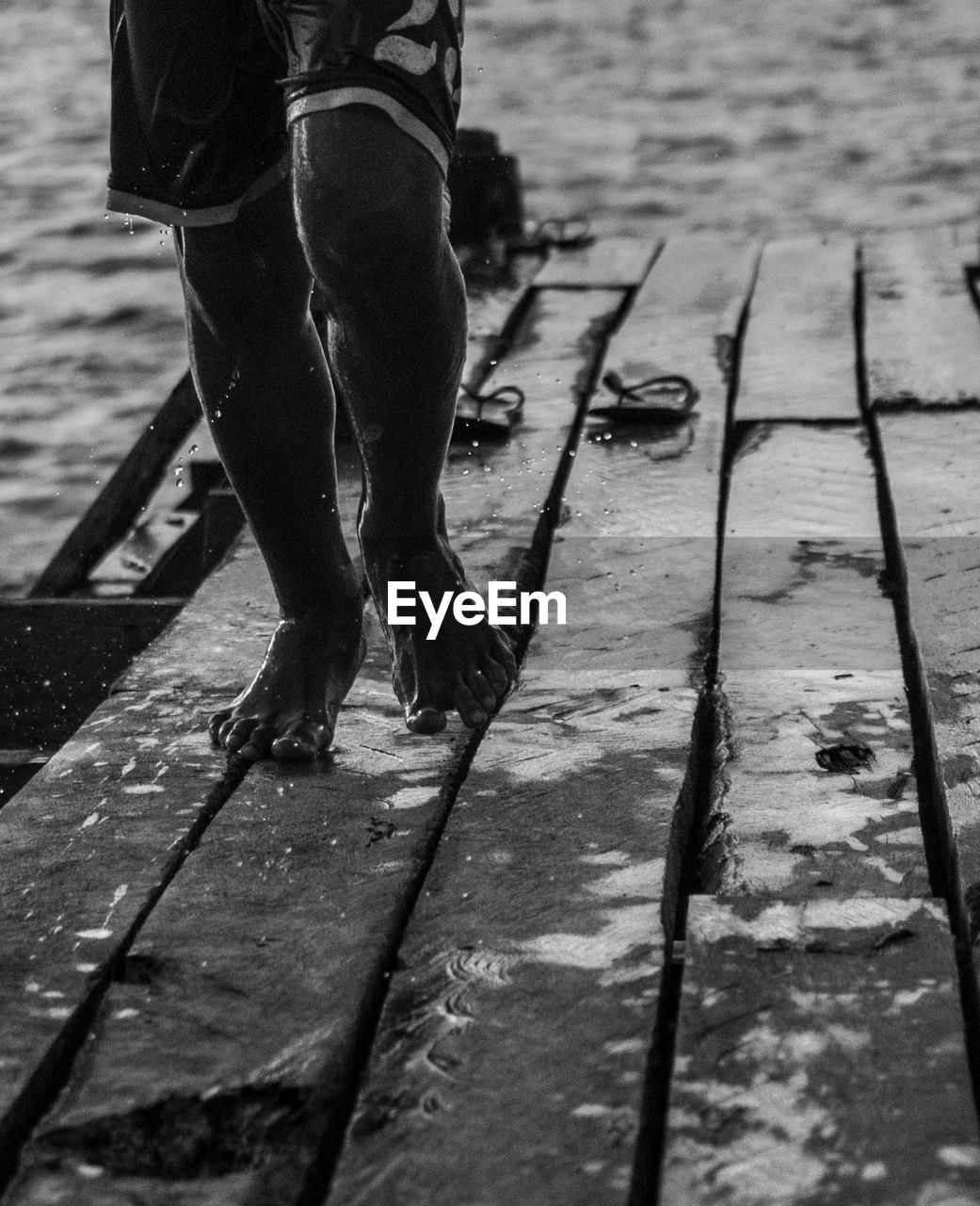 LOW SECTION OF MAN WALKING ON PIER