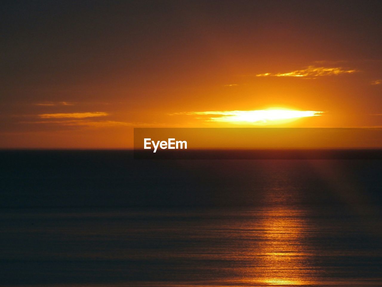 Scenic view of sea against sky at sunset