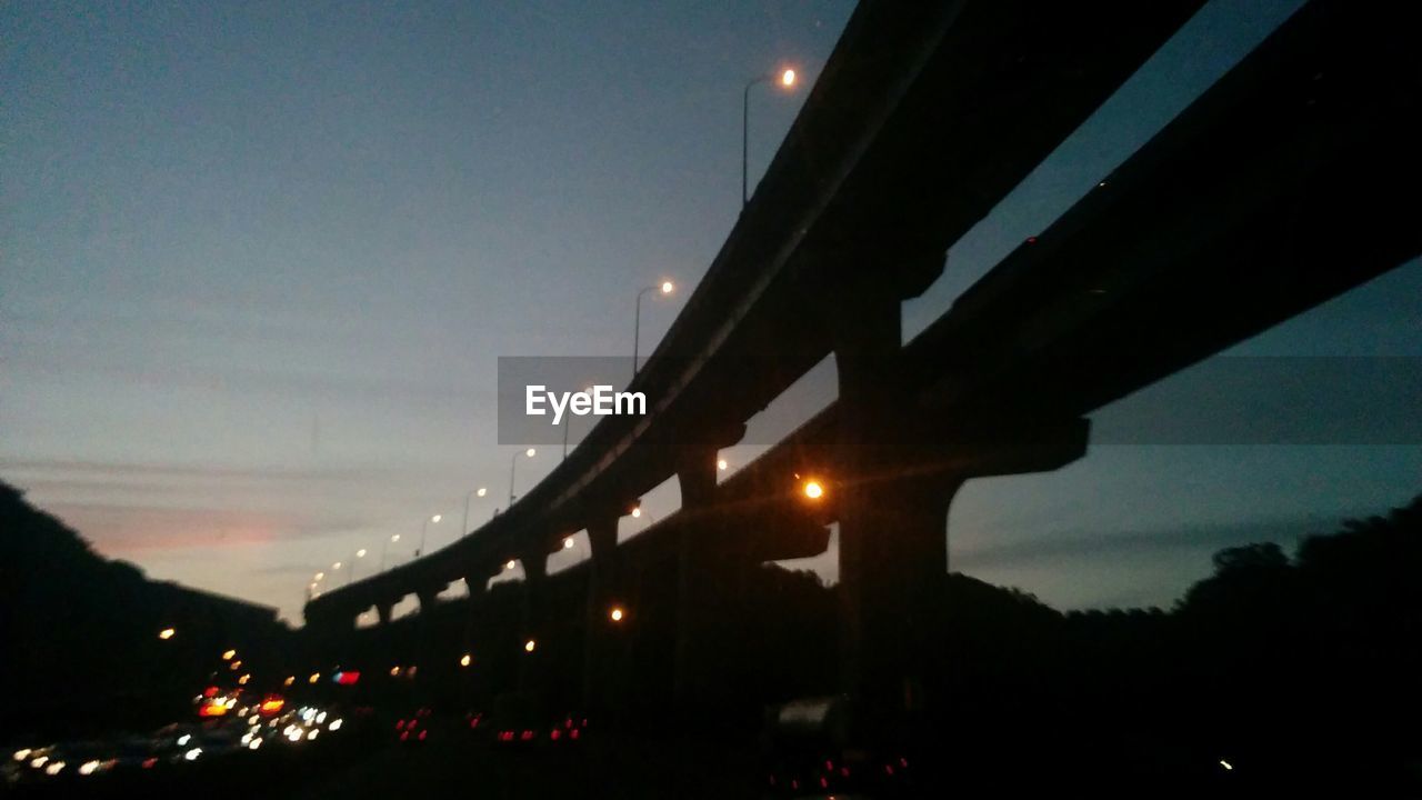 Low angle view of bridge against sky at dusk