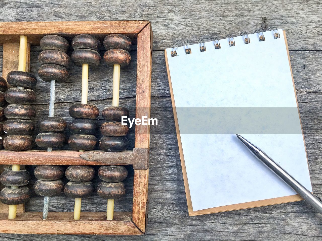 Directly above shot of book with abacus on table