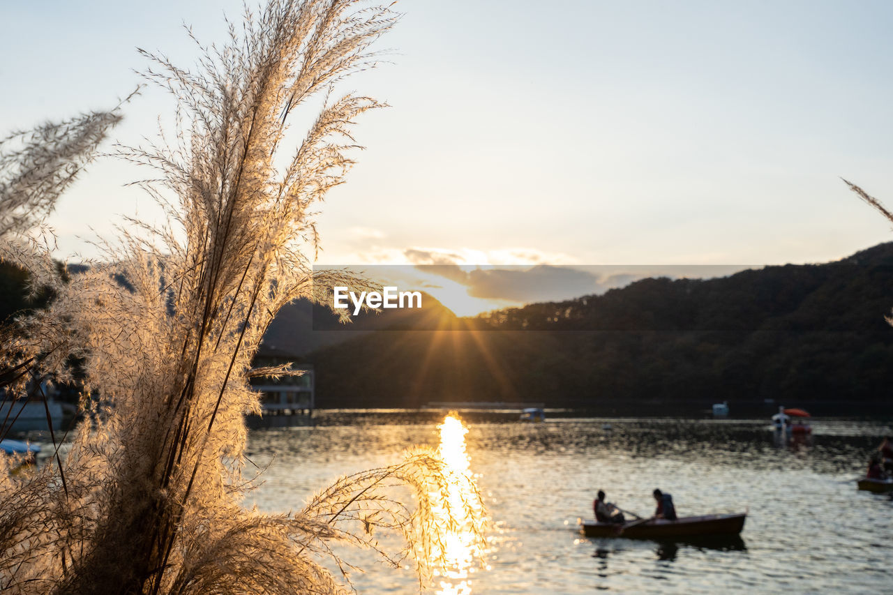 PEOPLE IN BOAT AT SUNSET