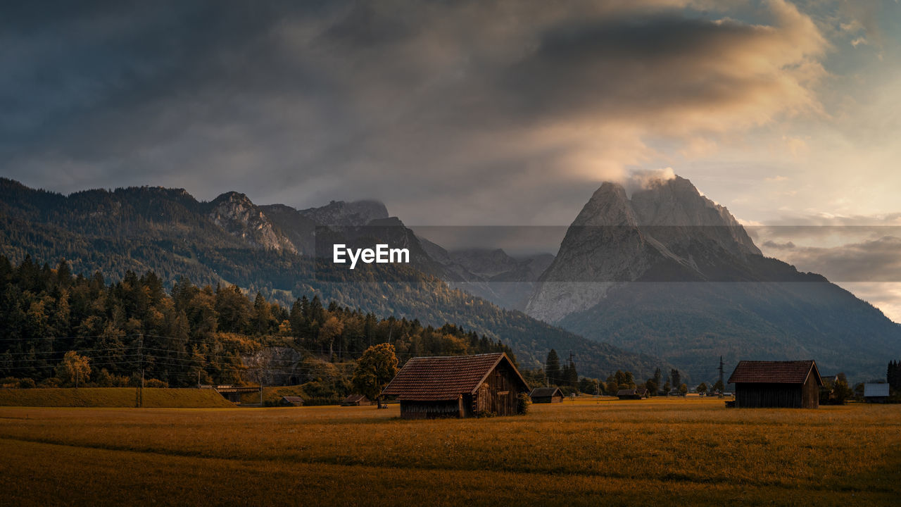 Scenic view of field and mountains against sky