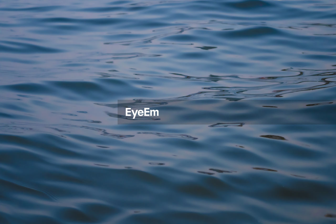 HIGH ANGLE VIEW OF RIPPLED WATER IN SEA