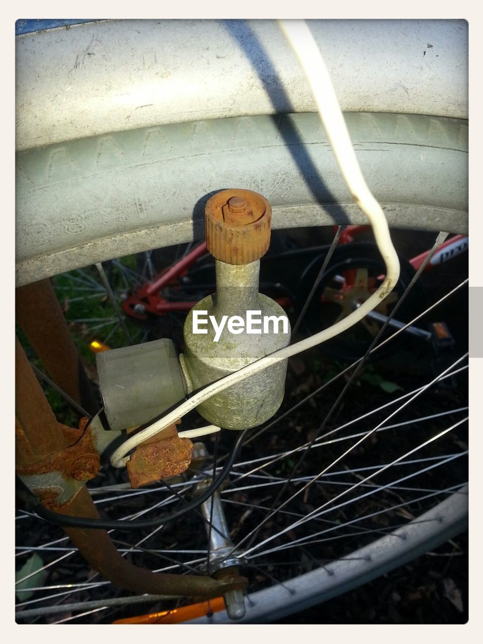 Close up of rusty dynamo on bike's wheel