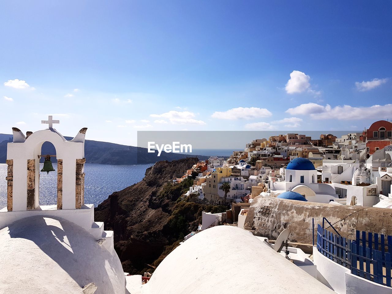 BUILDINGS BY SEA AGAINST BLUE SKY