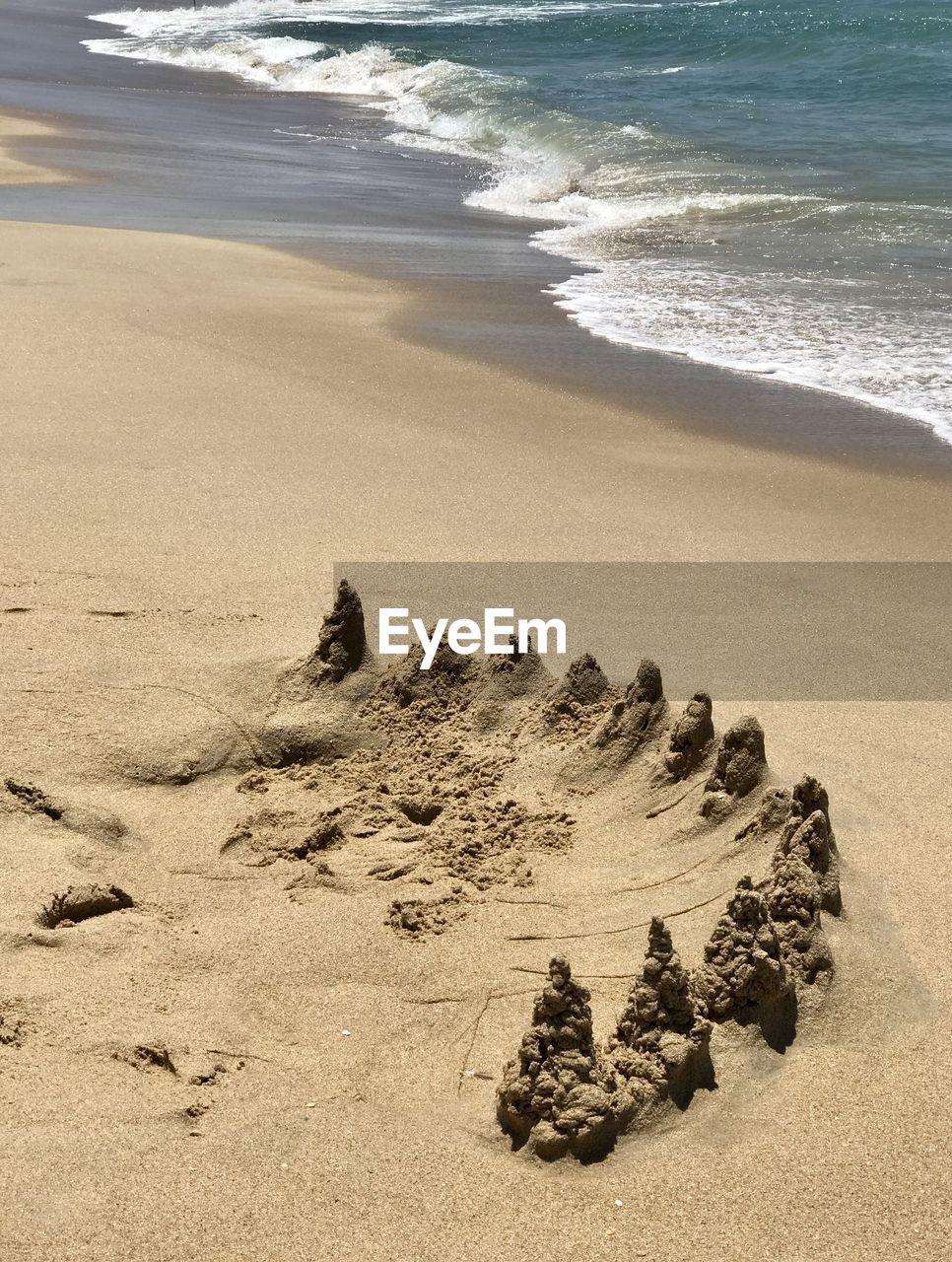 land, beach, sea, sand, water, body of water, nature, shore, footprint, wave, motion, beauty in nature, ocean, coast, tranquility, day, scenics - nature, wind wave, no people, rock, tranquil scene, outdoors, sports, sunlight, water sports, high angle view, sky