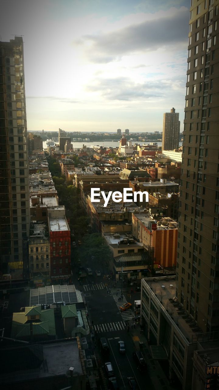 VIEW OF CITYSCAPE AGAINST CLOUDY SKY