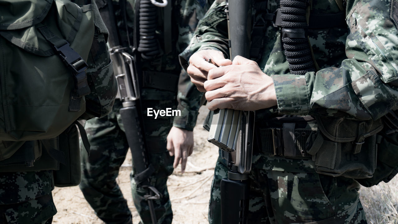 Close-up of army soldiers with rifle
