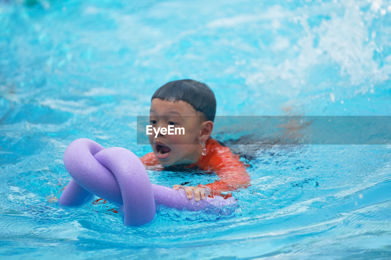 Cute boy swimming in pool