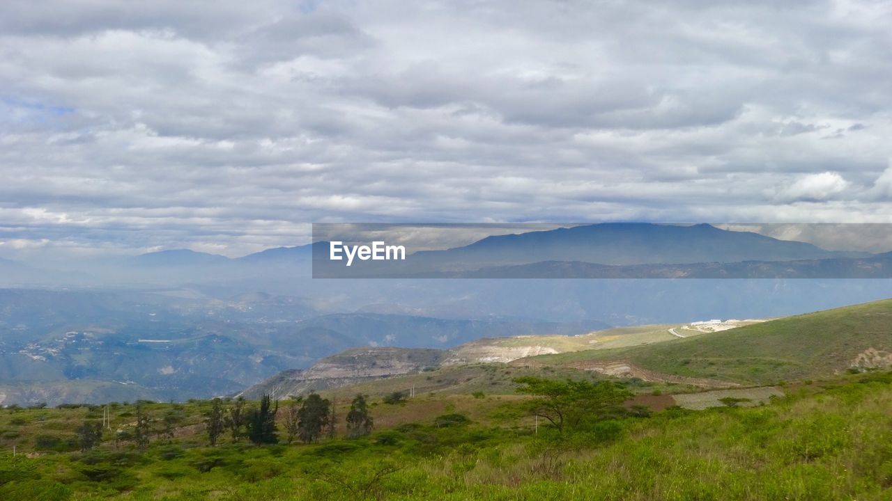 Scenic view of landscape and mountains against sky