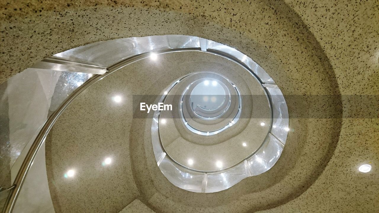 Directly below shot of illuminated spiral staircase