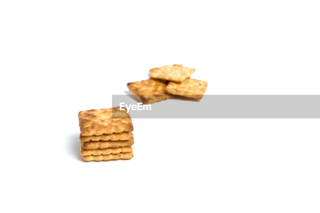 Stack of biscuits against white background