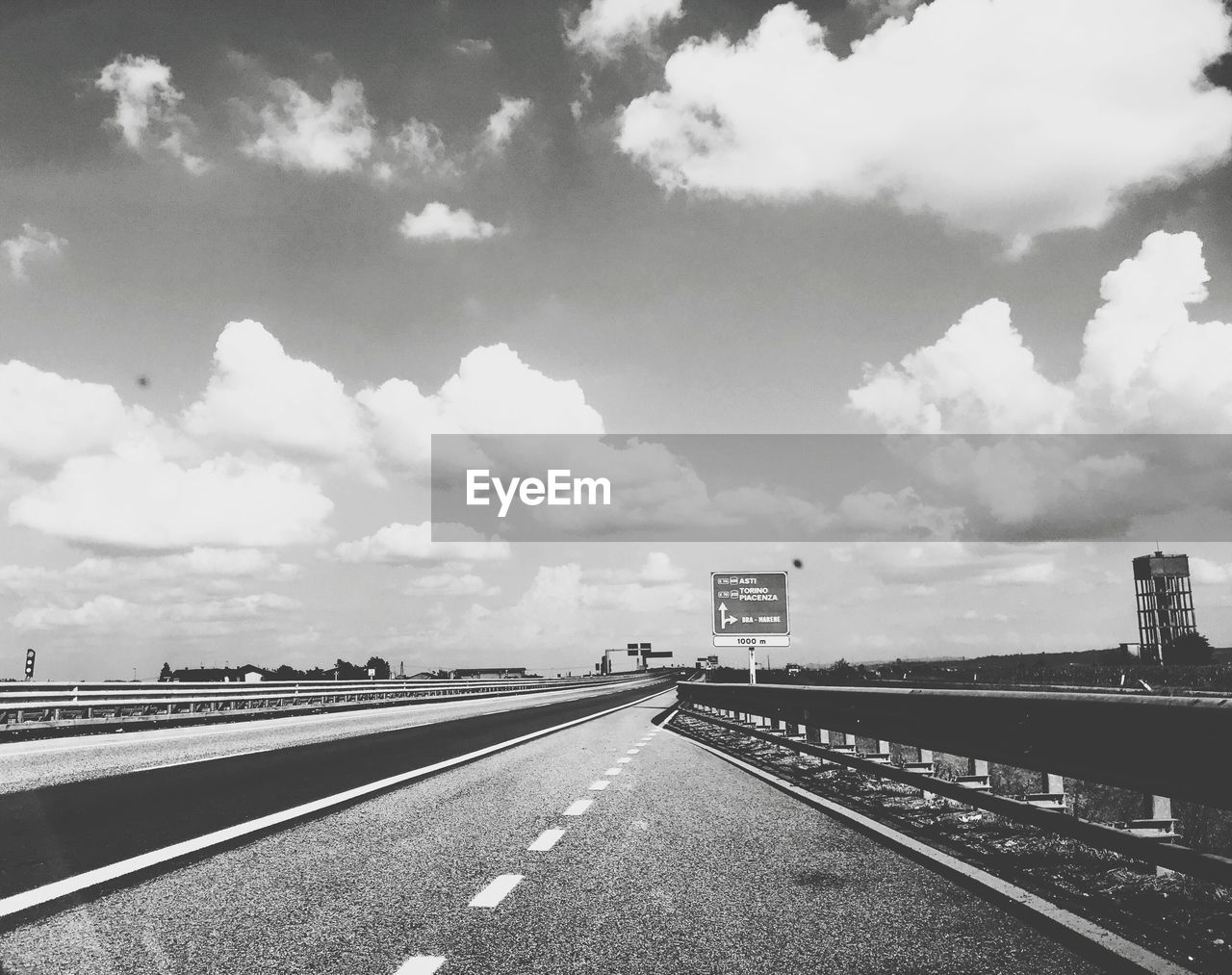 View of highway against cloudy sky