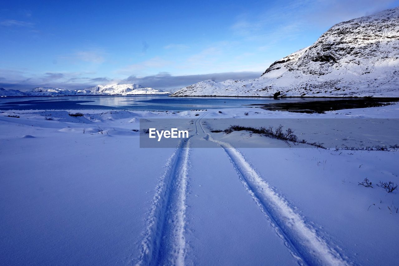 SNOW COVERED MOUNTAIN AGAINST BLUE SKY