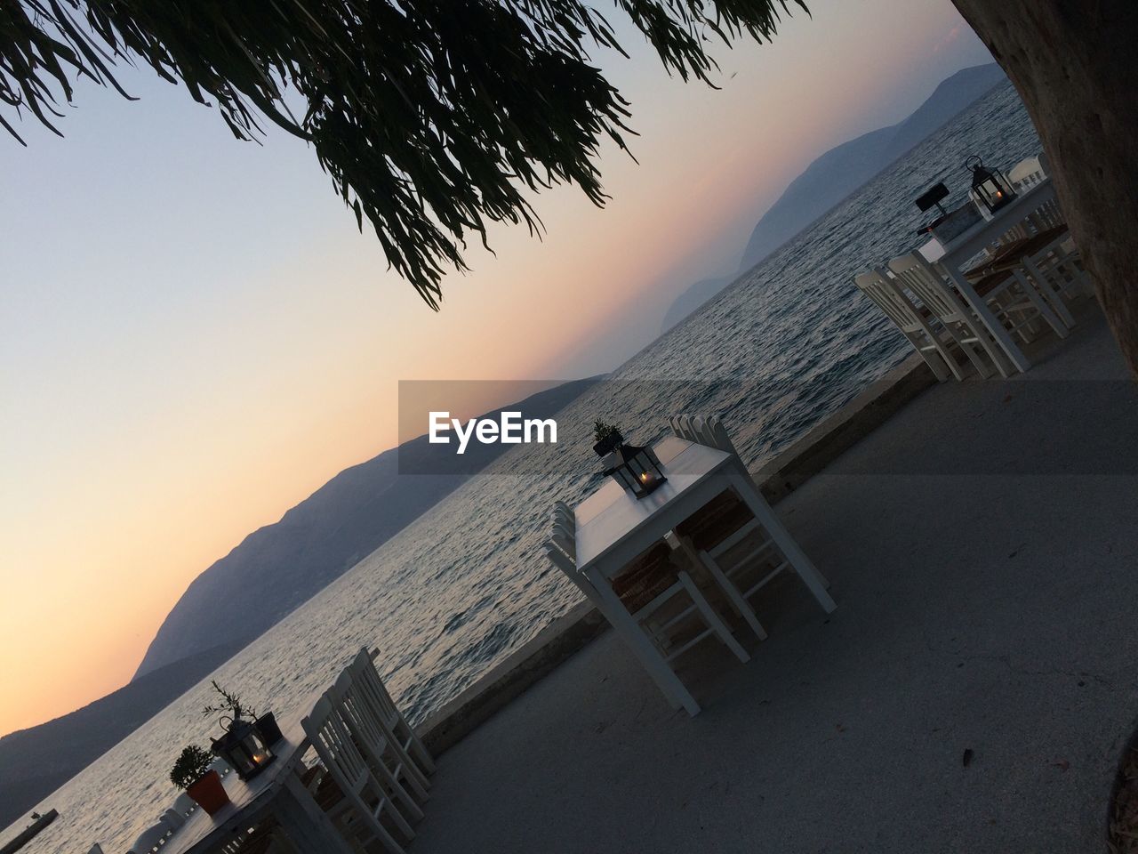 SCENIC VIEW OF BEACH AGAINST CLEAR SKY AT SUNSET