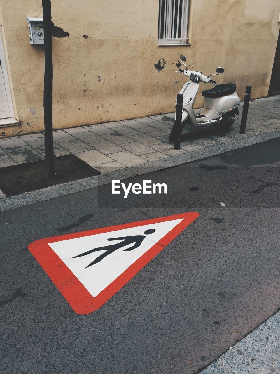 Pedestrian lane sign on asphalt road