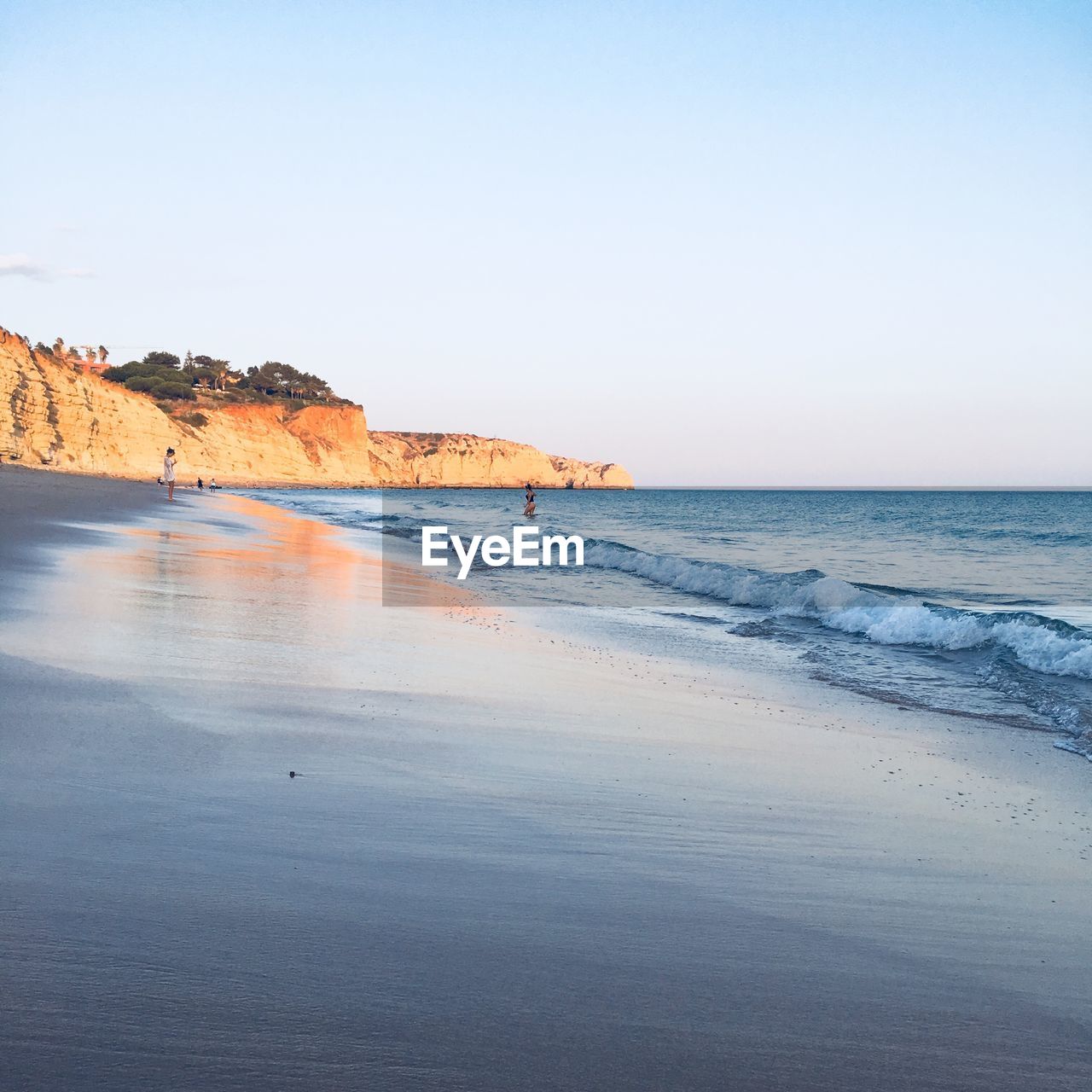 Scenic view of beach against clear sky